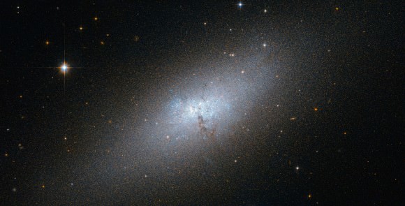 NGC 5253 is one of the nearest of the known Blue Compact Dwarf (BCD) galaxies, and is located at a distance of about 12 million light-years from Earth in the southern constellation of Centaurus. It is experiencing a starburst of hot, young stars, which could be caused by dark satellites. Image: NASA/ESA/Hubble.