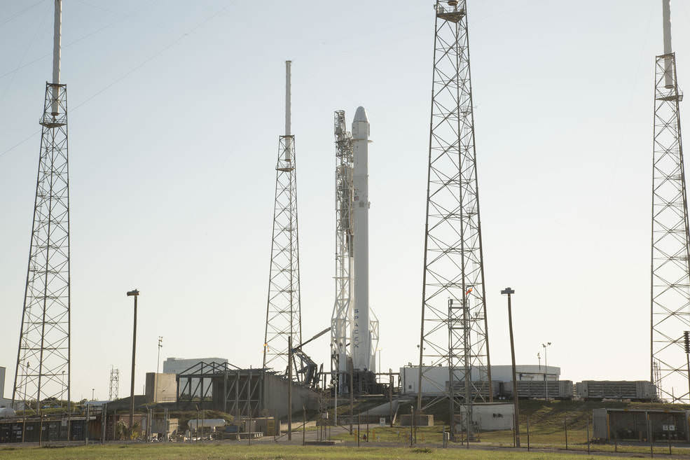 A Falcon 9 rocket with a Dragon spacecraft stand at Space Launch Complex 40 at Cape Canaveral Air Force Station before the CRS-8 mission to deliver experiments and supplies to the International Space Station.  Credits: SpaceX