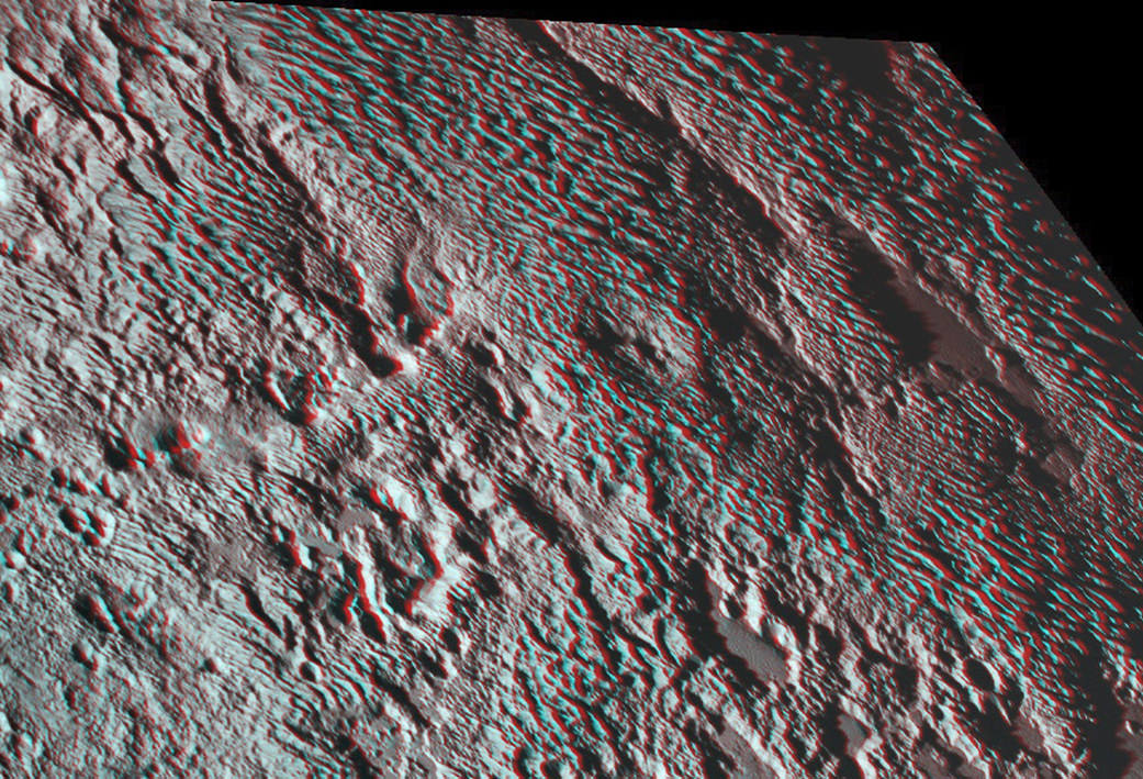 The amazing stereo view of a broad area informally named Tartarus Dorsa combines two images from the Ralph/Multispectral Visible Imaging Camera (MVIC) taken about 14 minutes apart on July 14, 2015. The first was taken when New Horizons was 16,000 miles (25,000 kilometers) away from Pluto, the second when the spacecraft was 10,000 miles (about 17,000 kilometers) away.   Credits: NASA/JHUAPL/SwRI