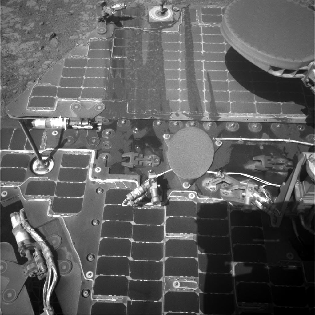 This March 21, 2016, image from the navigation camera on NASA's Mars rover Opportunity shows streaks of dust or sand on the vehicle's rear solar panel after a series of drives during which the rover was pointed steeply uphill. The tilt and jostling of the drives affected material on the rover deck.  Credits: NASA/JPL-Caltech