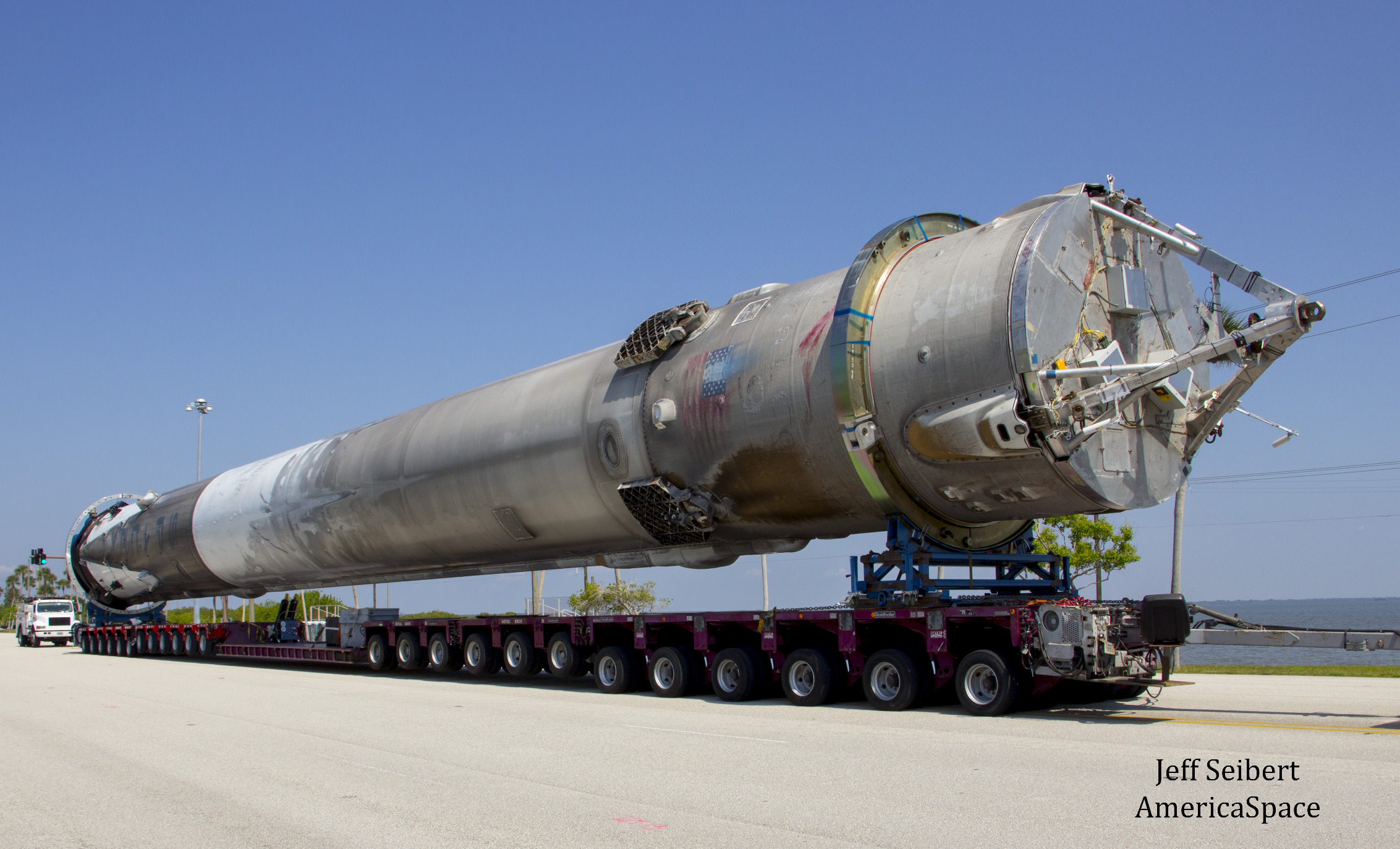 First stage booster from SpaceX JCSAT-14 launch was transported horizontally to SpaceX hangar at pad 39A at the Kennedy Space Center, Florida. Credit: Jeff Seibert/AmericaSpace