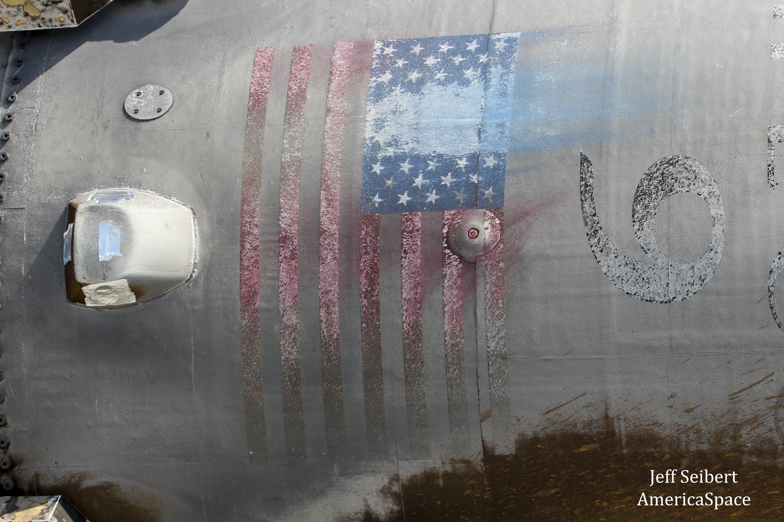 Scorched skin and US flag on recovered SpaceX first stage booster during roll  to SpaceX hanger at Kennedy Space Center, Florida on May 16, 2016.  Credit: Jeff Seibert/AmericaSpace