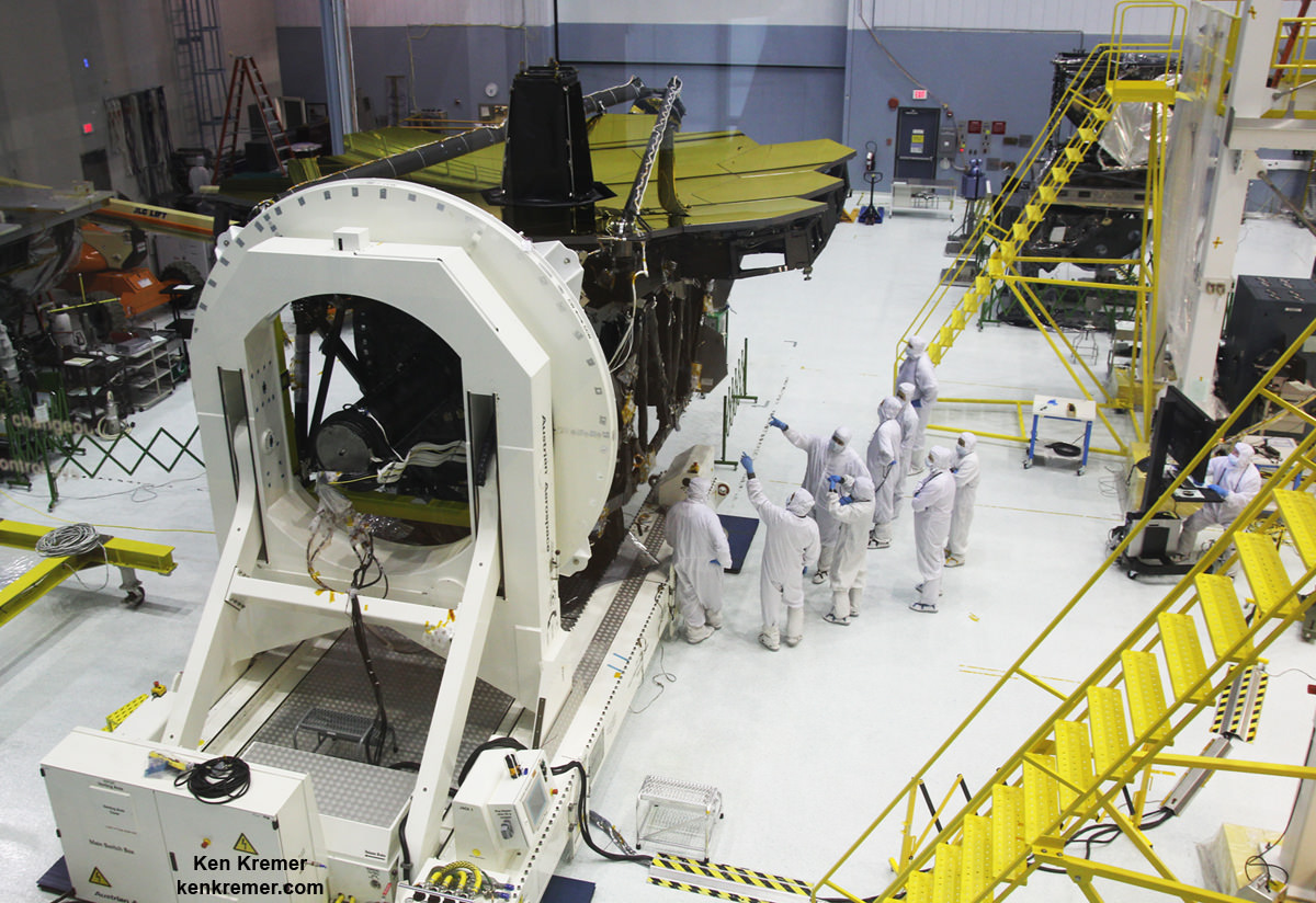 All 18 gold coated primary mirrors of NASA’s James Webb Space Telescope are seen fully unveiled after removal of protective covers installed onto the backplane structure, as technicians work inside the massive clean room at NASA's Goddard Space Flight Center in Greenbelt, Maryland on May 3, 2016.  The secondary mirror mount booms are folded down into stowed for launch configuration. Credit: Ken Kremer/kenkremer.com