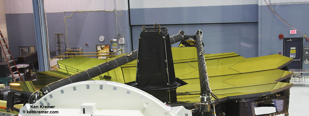 Gold coated primary mirrors newly exposed on spacecraft structure of NASA’s James Webb Space Telescope inside the massive clean room at NASA's Goddard Space Flight Center in Greenbelt, Maryland on May 3, 2016.   Aft optics subsystem stands upright at center of 18 mirror segments between stowed secondary mirror mount booms.  Credit: Ken Kremer/kenkremer.com
