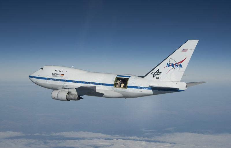 SOFIA in flight, with its telescope exposed. SOFIA is an infrared observatory in a converted Boeing 747. It takes its 2.7 meter telescope up into the stratosphere, (38,000 to 45,000 ft) where it's above 95% of the Earth's infrared-blocking atmosphere. Image: NASA/Jim Ross