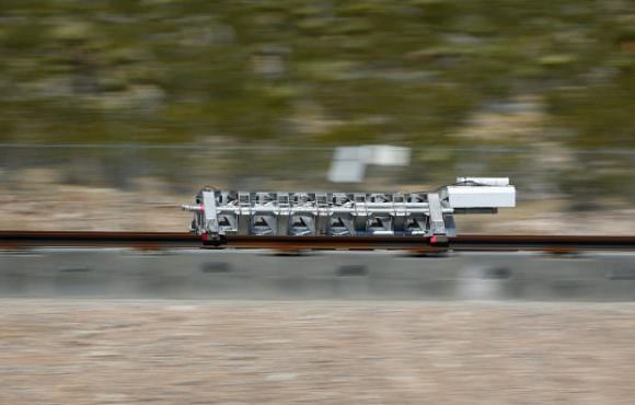 A sled speeds down a track during the test of a Hyperloop One propulsion system Wednesday in North Las Vegas, Nev. Credit: John Locher/The Associated Press)