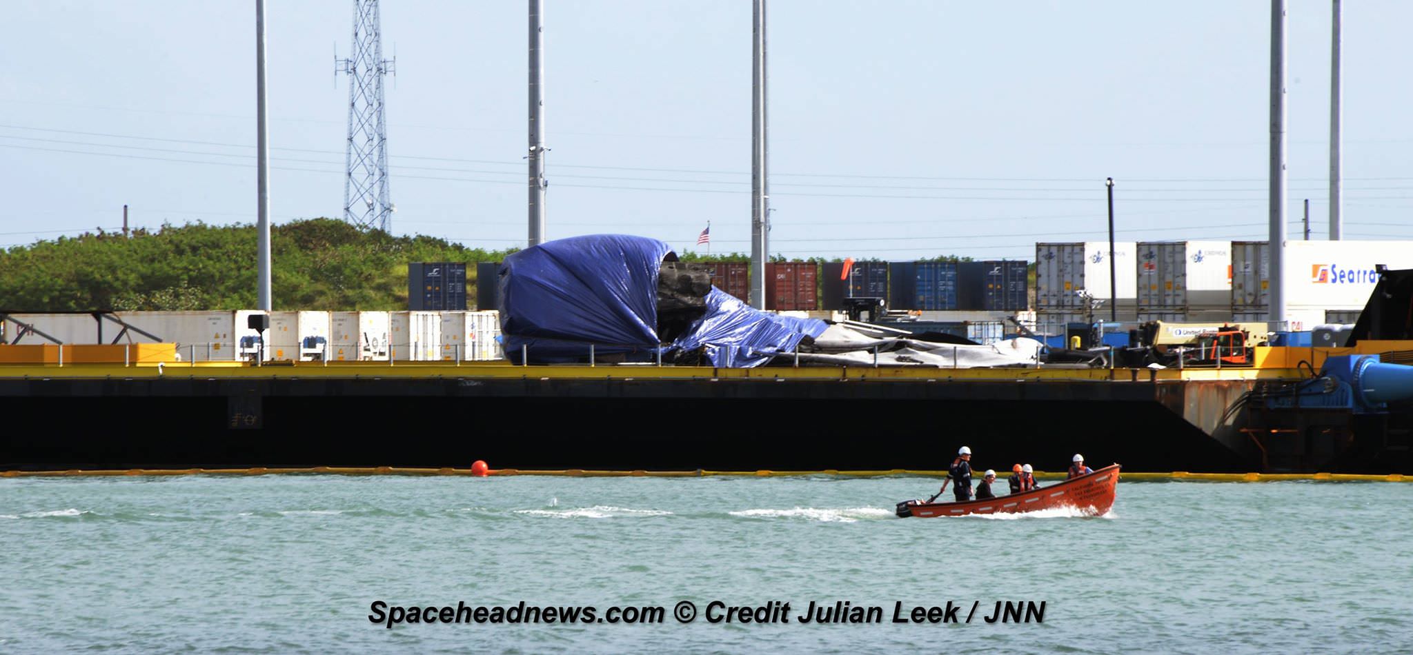 Flattened SpaceX Falcon 9 first stage arrived into Port Canaveral, FL atop a droneship late Saturday, June 18 after hard landing and tipping over following successful June 15, 2016  commercial payload launch.  Credit: Julian Leek  