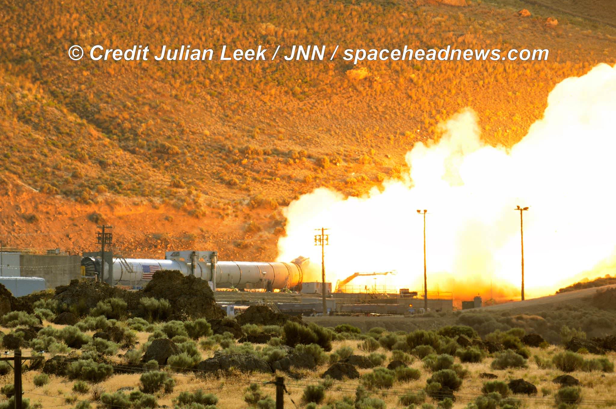 Ignition of the qualification motor (QM-2) booster during test firing for NASA’s Space Launch System as seen on Tuesday, June 28, 2016, at Orbital ATK Propulsion System's (SLS) test facilities in Promontory, Utah.  Credit: Julian Leek 