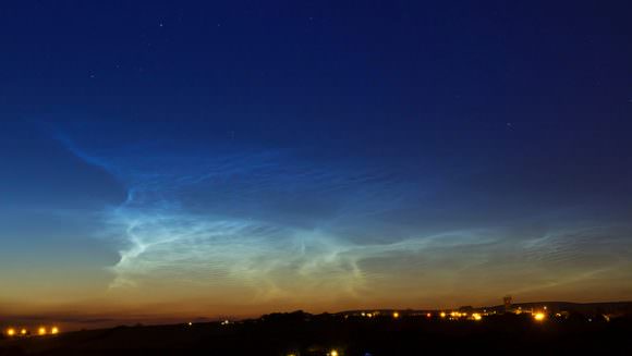 A display of noctilucent clouds over Blackrod, UK. Image credit and copyright: Dave Walker.