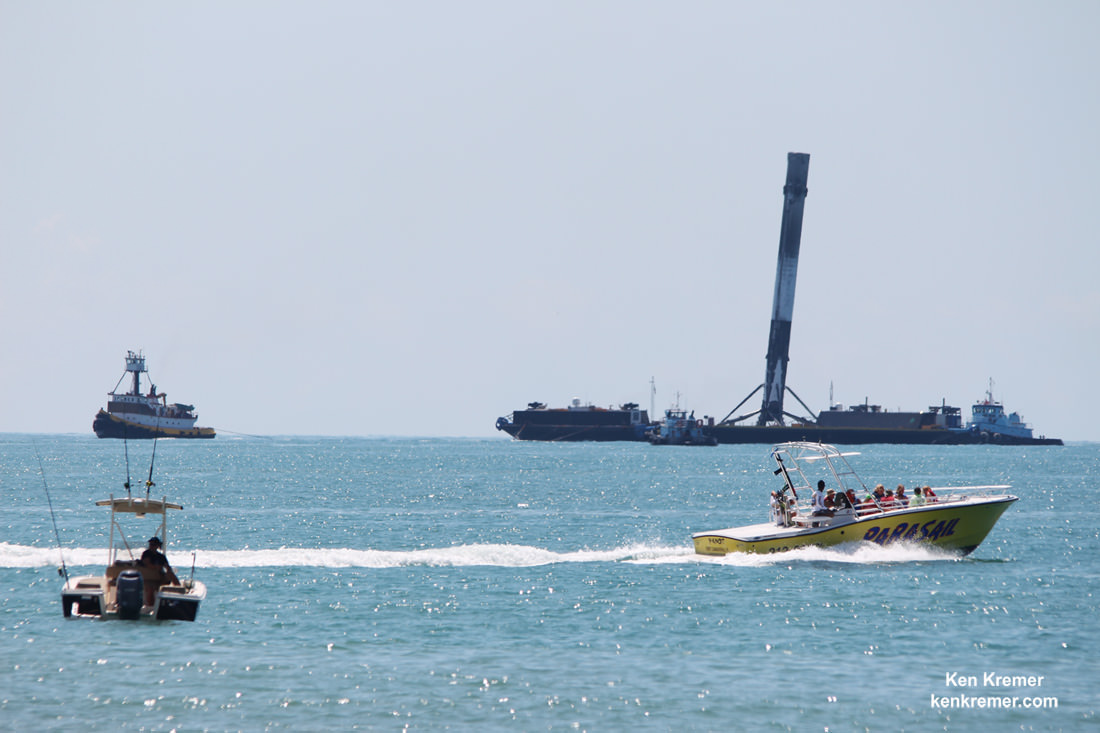 Incredible sight of pleasure craft zooming past SpaceX Falcon 9 booster from Thaicom-8 launch on May 27, 2016 as it arrives at the mouth of Port Canaveral, FL,  atop droneship platform on June 2, 2016.  Credit: Ken Kremer/kenkremer.com