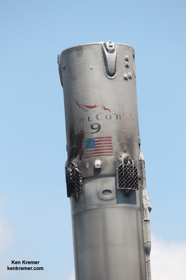 Up close view of top of SpaceX Falcon 9 booster showing decal, US flag, grid fins and nitrogen cold gas thruster as it floats along the Port Canaveral channel atop droneship platform on June 2, 2016 following Thaicom-8 launch on May 27, 2016.  Credit: Ken Kremer/kenkremer.com