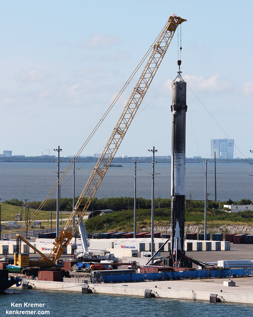 Recovered SpaceX Falcon 9 from Thaicom-8 mission after craning off ‘OCISLY’ droneship to ground processing cradle at Port Canaveral, FL.  Workers had removed the first of four landing legs in this view from June 3, 2016. Credit: Ken Kremer/kenkremer.com