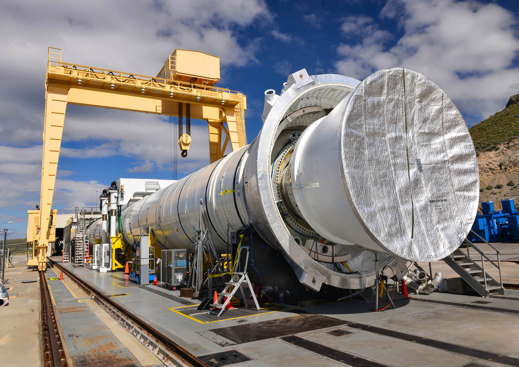 The five-segment Qualification motor-2 (QM-2) test booster for NASA's Space Launch System (SLS) being readied for full duration firing at Orbital ATK test facility in Promontory, Utah, on June 28, 2016.  Credit: NASA