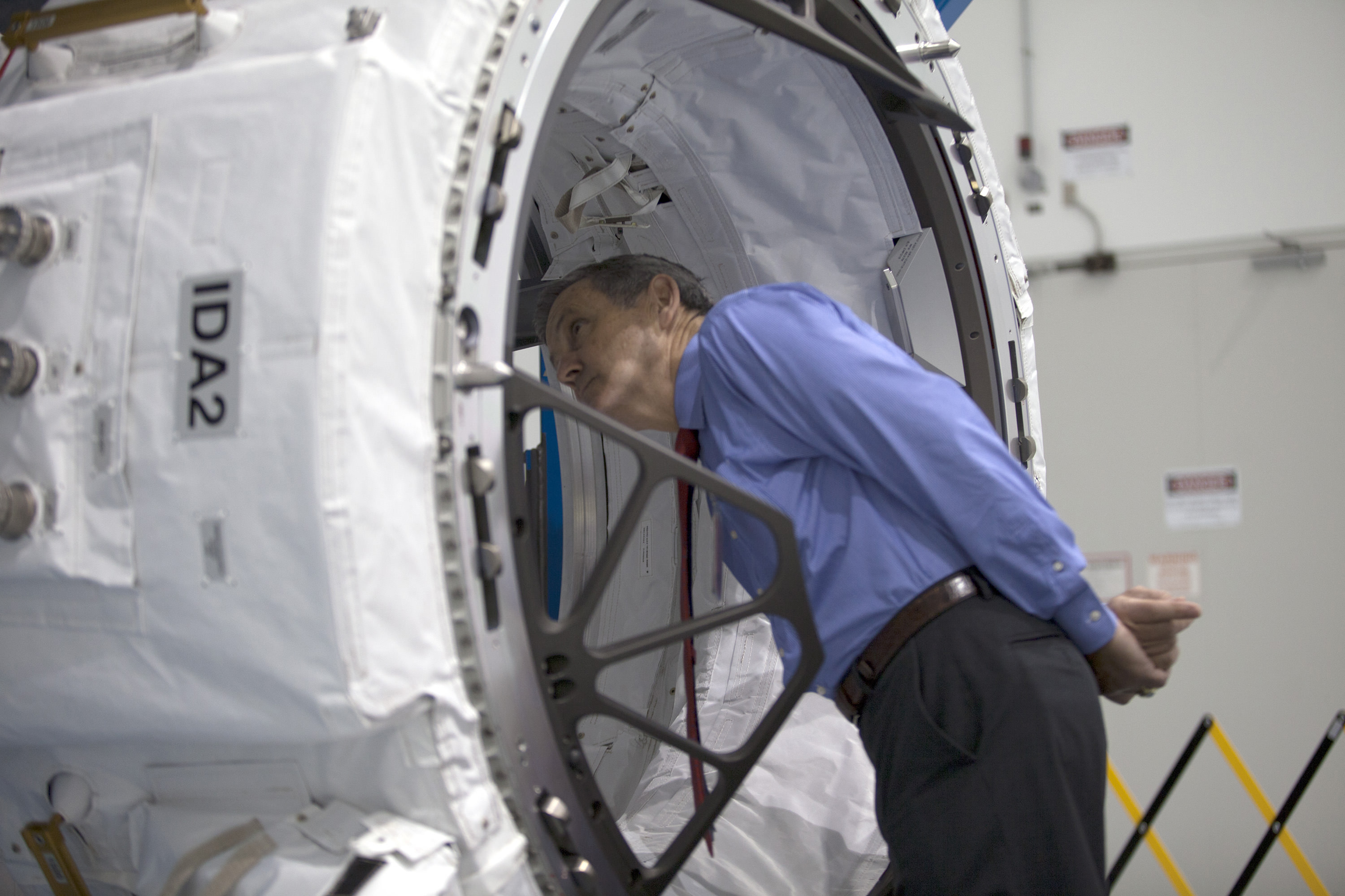 Former astronaut Bob Cabana, director of NASA's Kennedy Space Center in Florida, surveys the IDA-2 inside the Space Station Processing Facility.  Credits: NASA