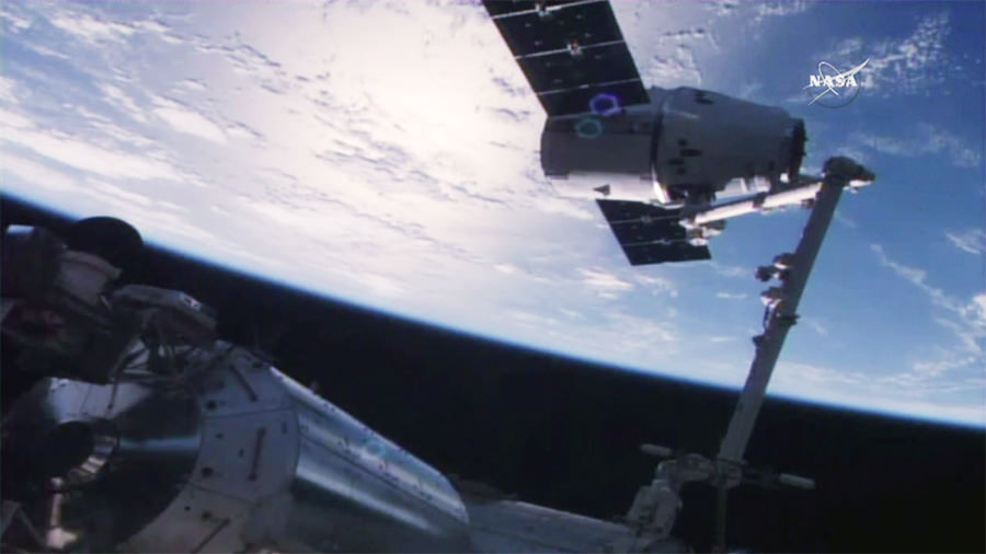 The SpaceX Dragon is captured in the grips of the Canadarm2 robotic arm. Credit: NASA TV