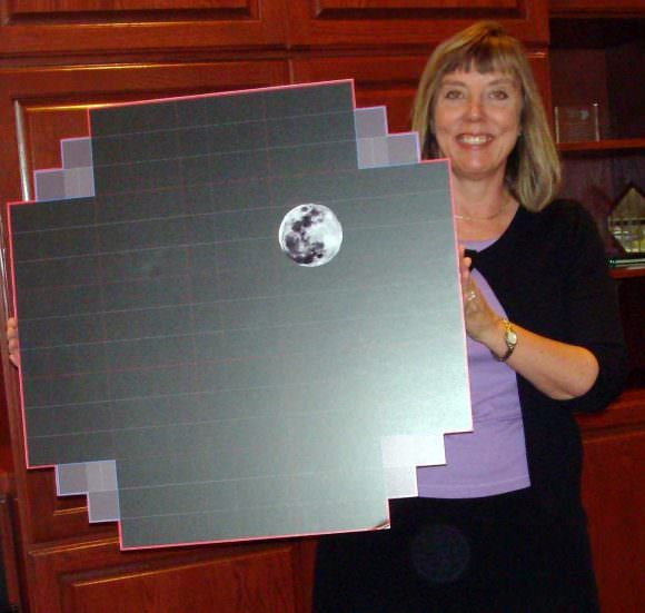 Suzanne Jacoby with the LSST focal plane array scale model. The image of the moon (30 arcminutes) is placed there for scale of the Field of View. Credit: Large Synoptic Survey Telescope (CC-SA 4.0)