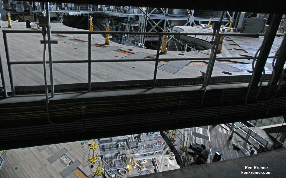 View looking out to both halves of Platform F and down to Platform G showing the outer mold line snaking around the SLS core stage and a solid rocket booster from the 190 foot level under construction inside the VAB High Bay 3 on July 28, 2016 at the Kennedy Space Center in Florida.  Credit: Ken Kremer/kenkremer.com