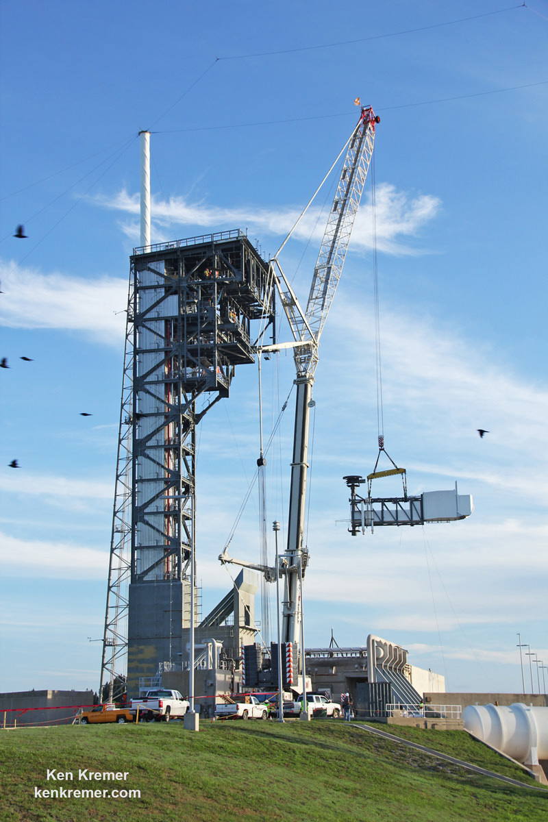 A crane lifts the Crew Access Arm and White Room for Boeing's CST-100 Starliner spacecraft for mating to the Crew Access Tower at Cape Canaveral Air Force Station’s Space Launch Complex 41.  Astronauts will walk through the arm to board the Starliner spacecraft stacked atop a United Launch Alliance Atlas V rocket.  Credit: Ken Kremer/kenkremer.com 