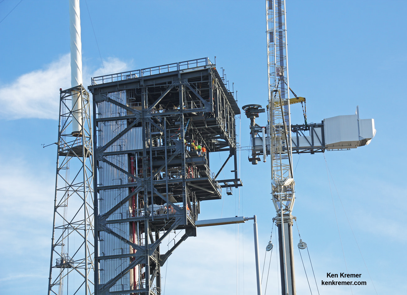 The Crew Access Arm and White Room for Boeing's CST-100 Starliner spacecraft approaches the notch for mating to the Crew Access Tower at Cape Canaveral Air Force Station’s Space Launch Complex 41 at level 13 on Aug. 15, 2016, as workers observe from upper tower level.  Astronauts will walk through the arm to board the Starliner spacecraft stacked atop a United Launch Alliance Atlas V rocket.  Credit: Ken Kremer/kenkremer.com