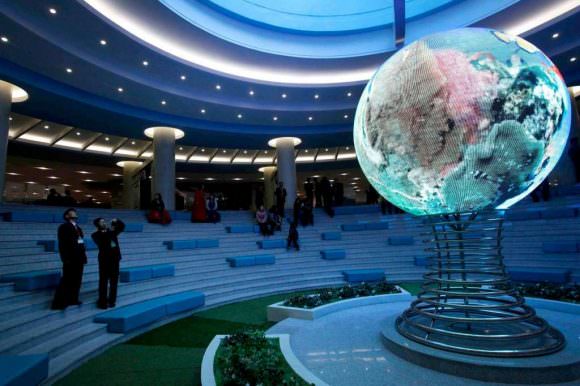 Visitors takes photos of an illuminated model of a globe at the Sci-Tech Complex in Pyongyang, North Korea. Credit: Kim Kwang Hyon/AP 