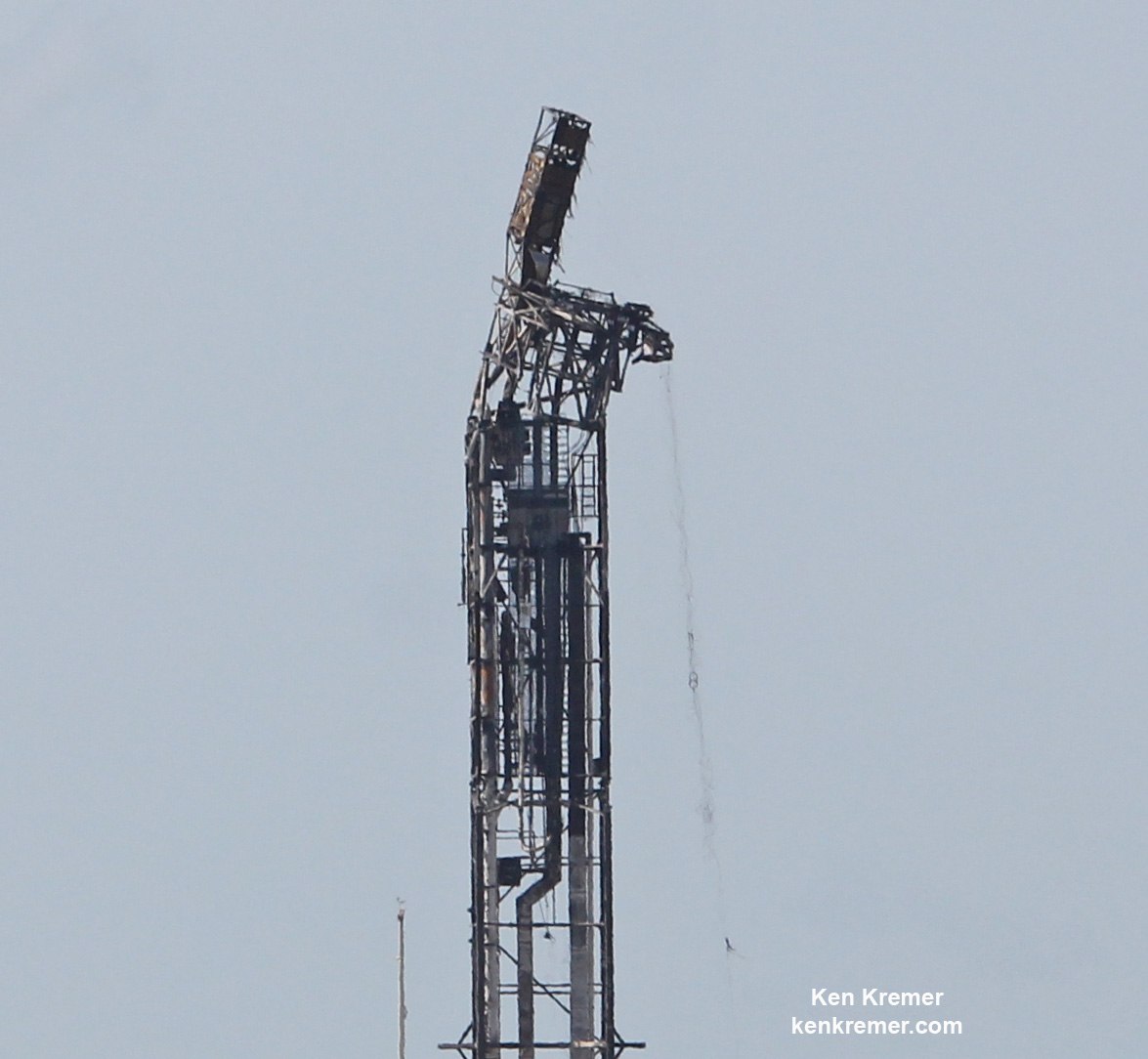 Up close view of top of mangled SpaceX Falcon 9 strongback with dangling cables (at right) as seen on Sept. 7 after prelaunch explosion destroyed the rocket and AMOS-6 payload and damaged the pad at Space Launch Complex-40 at Cape Canaveral Air Force Station, FL on Sept. 1, 2016 . Credit: Ken Kremer/kenkremer.com