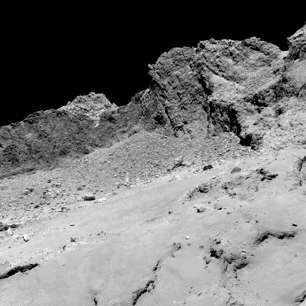Landscape on Comet 67P taken from just 10 miles (16 km) up late Thursday evening during Rosetta's free fall . The image measures 2,014 feet (614 meters) across or just under a half-mile. At typical walking speed, you could walk from one end to the other in 10 minutes. Credit: ESA/Rosetta