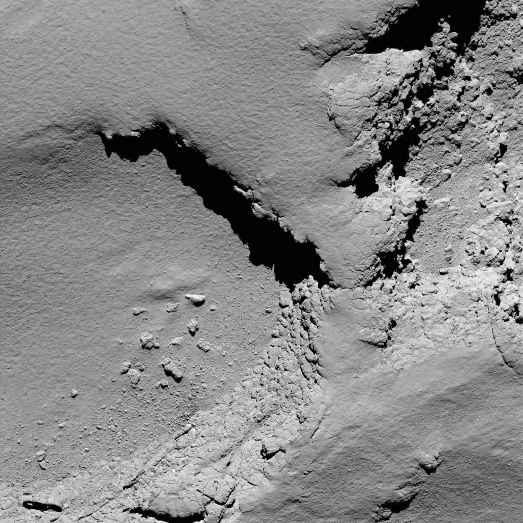 As Rosetta continues its descent onto the Ma'at region on the small lobe of Comet 67P/Churyumov-Gerasimenko, the OSIRIS narrow-angle camera captured this image at 08:18 GMT from an altitude of about 5.8 km. The image shows dust-covered terrains, exposed walls and a few boulders on Ma'at, not far from the target impact region (not visible in this view - located below the lower edge).Copyright ESA/Rosetta/MPS for OSIRIS Team MPS/UPD/LAM/IAA/SSO/INTA/UPM/DASP/IDA