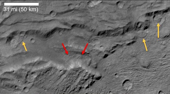 Scientists from NASA's New Horizons mission have spotted signs of long run-out landslides on Pluto's largest moon, Charon. Arrows mark indications of landslide activity. Credit: NASA/Johns Hopkins University Applied Physics Laboratory/Southwest Research Institute.