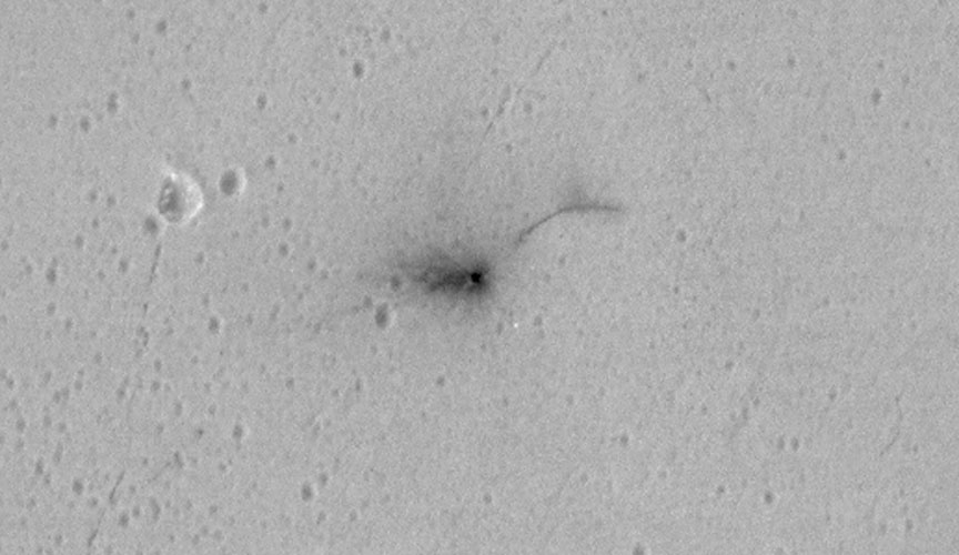 A closeup of the dark, approximately circular crater about 7.9 feet (2.4 meters) in diameter marking the crash of the Schiaparelli test lander on Mars. The photo was taken on October 25 by NASA's Mars Reconnaissance Lander (MRO). Credit: 
