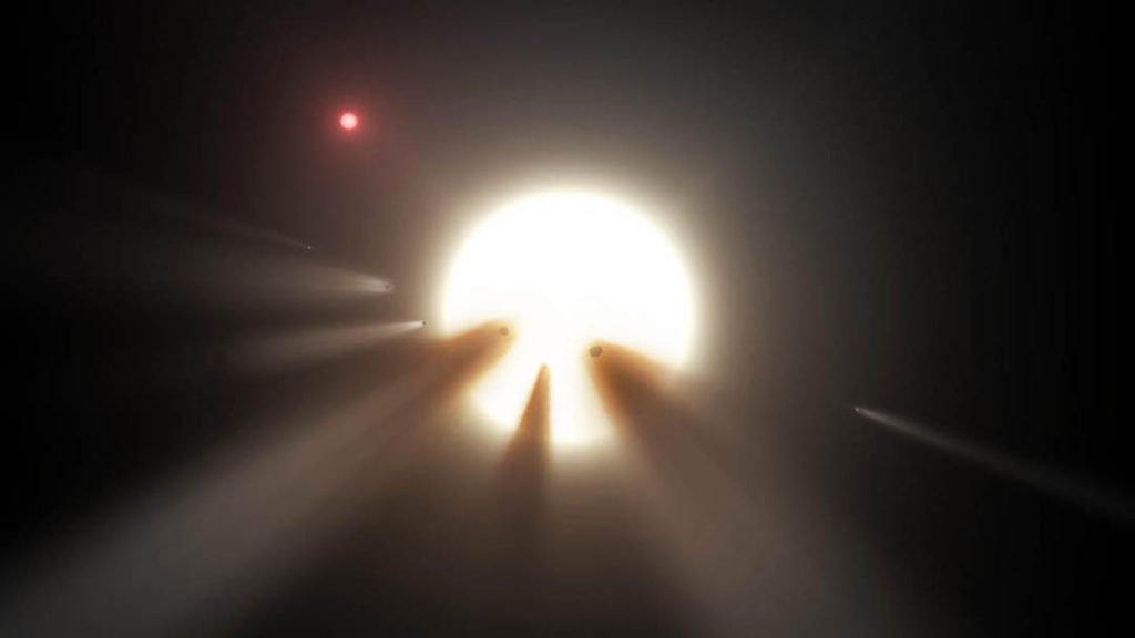 Artist's impression of an orbiting swarm of dusty comet fragments around Tabby's Star. Could these be responsible for its peculiar dips in brightness or is there a biological reason?  A small red dwarf star (above, left) lies near Tabby's. Credit: NASA/JPL-Caltech