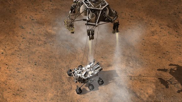Artists concept of the moment the Curiosity rover touches down on the Martian surface, suspended on a bridle beneath the spacecraft's descent stage. Credit: NASA/JPL-Caltech