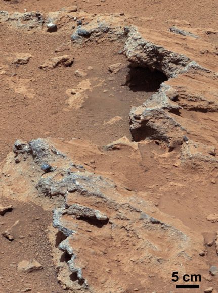 This geological feature on Mars is exposed bedrock made up of smaller fragments cemented together, or what geologists call a sedimentary conglomerate, and is evidence for an ancient, flowing stream. Some of embedded and loose gravel are round in shape, leading the Curiosity science team to conclude it were transported by a vigorous flow of water. Curiosity's 100-millimeter Mastcam telephoto lens on its 39th sol of the mission (Sept. 14, 2012). Credit: NASA/JPL-Caltech/MSSS