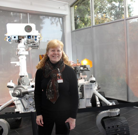 Author Nancy Atkinson at JPL with a model of the Curiosity Rover.