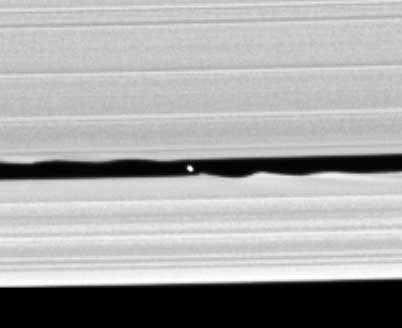 This image shows the moon Daphnis in the Keeler gap in Saturn's A ring. The moon's gravity causes the wave shapes in the rings. By NASA/JPL/Space Science Institute - http://www.esa.int/SPECIALS/Cassini-Huygens/SEM1XQ5TI8E_1.html, Public Domain, https://commons.wikimedia.org/w/index.php?curid=17953334