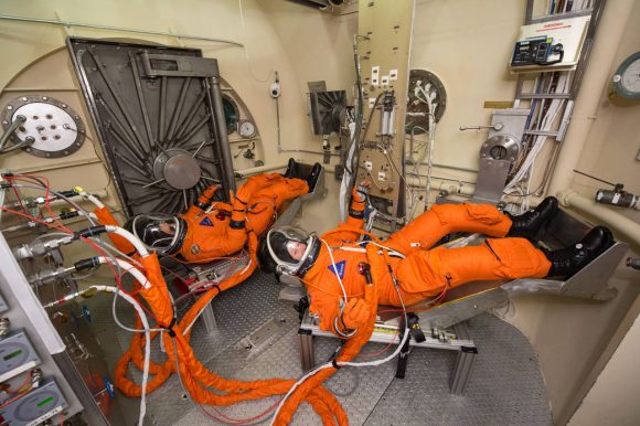 Astronauts test out the Modified Advanced Crew Escape Suit (MACES), a closed-loop version of the launch and entry suits worn by space shuttle astronauts that may be used in the Orion spacecraft.  The suit will contain all the necessary functions to support life and is being designed to enable spacewalks and sustain the crew in the unlikely event the spacecraft loses pressure. Credit: NASA/Bill Stafford. 
