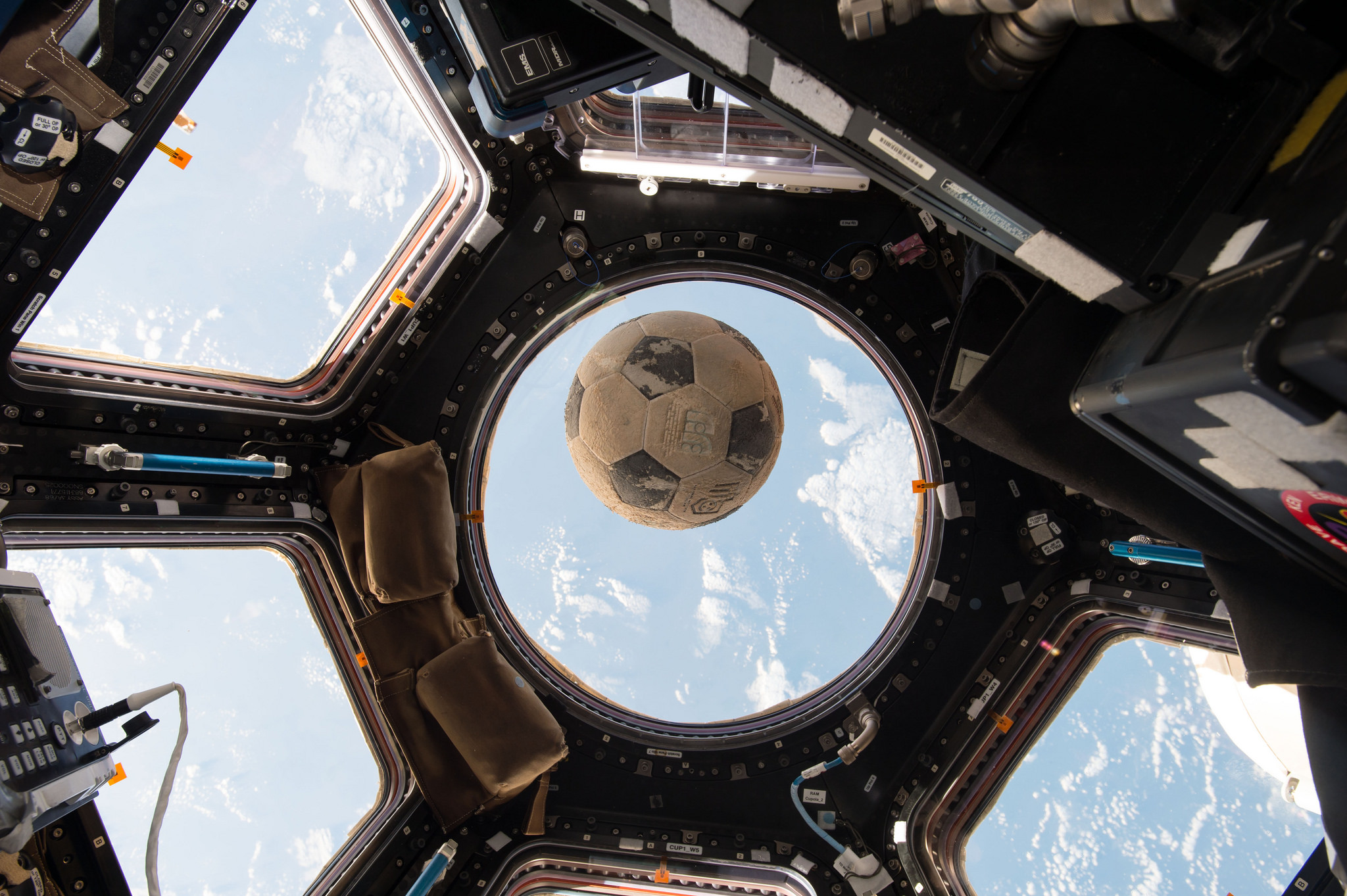 Astronaut Shane Kimbrough took this photo of the Challenger soccer ball floating in front of the ISS's cupola window to mark NASA's day of remembrance for the Challenger disaster. Image: NASA