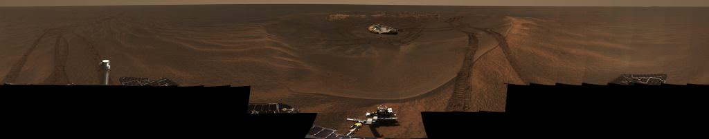 This panorama image, called "Lion King" was assembled from 558 images totalling over 75 megabytes. The rock outcrop, the landing pad, and the rover's tracks are all clearly visible. Image: NASA/JPL/Cornell