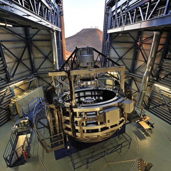 VISTA inside its enclosure at Paranal. VISTA has a 4.1 meter mirror, and its job is to survey large sections of the sky at once. In the background is the ESO's Very Large Telescope. Image: G. Hüdepohl 