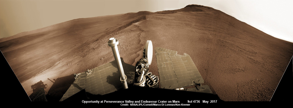 Opportunity rover looks south from the top of Perseverance Valley along the rim of Endeavour Crater on Mars in this partial self portrait including the rover deck and solar panels. Perseverance Valley descends from the right and terminates down near the crater floor. This navcam camera photo mosaic was assembled from raw images taken on Sol 4736 (20 May 2017) and colorized. Credit: NASA/JPL/Cornell/Marco Di Lorenzo/Ken Kremer/kenkremer.com
