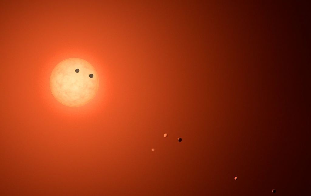 This is an artist's impression of the TRAPPIST-1 system, showing all seven planets. Image Credit: NASA