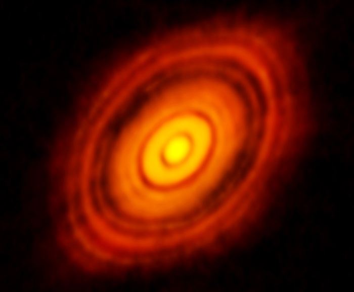 Image du disque de formation de planètes HL Tau (ne faisant pas partie de cette étude) prise avec le Atacama Large Millimeter Array.  Les astronomes pensent que les voies sombres sont celles où les planètes se forment.  Crédit : ALMA (ESO / NAOJ / NRAO)