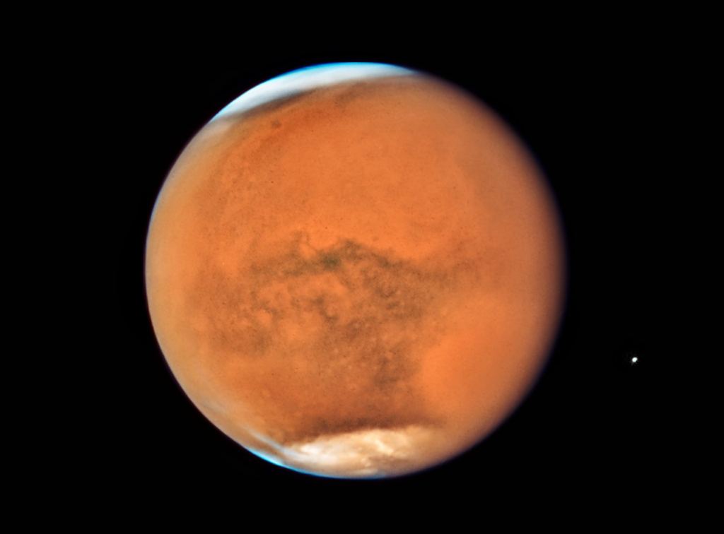In mid-July 2018 the NASA/ESA Hubble Space Telescope observed Mars, only 13 days before the planet made its closest approach to Earth in 2018. While previous images showed detailed surface features of the planet, this new image is dominated by a gigantic sandstorm enshrouding the entire planet. Global dust storms — lasting for weeks or months — tend to happen during the spring and summer in the southern hemisphere, when Mars is closest to the Sun and heating is at a maximum, leading to greater generation of winds. Image Credit: NASA/ESA/Hubble STscI