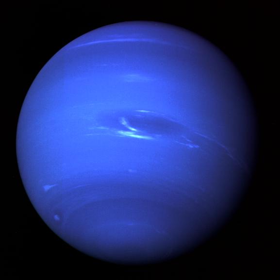 Neptune, as seen by Voyager 2 in 1989. The deep blue color applied helped enhance the view of features in the atmosphere. Image Credit: NASA/JPL
