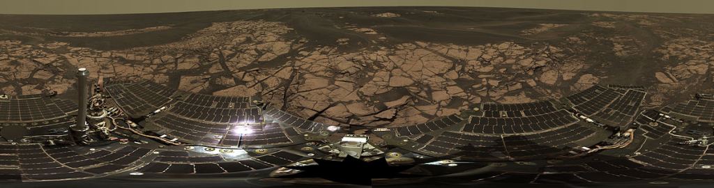 A panorama image of the Opportunity rover, showing the solar panels. The rover's science operations were shut down because of the growing global dust storm. By NASA/JPL-Caltech/Cornell - http://marsrovers.jpl.nasa.gov/gallery/press/opportunity/20060104a.html / http://photojournal.jpl.nasa.gov/catalog/PIA03270, Public Domain, https://commons.wikimedia.org/w/index.php?curid=514339