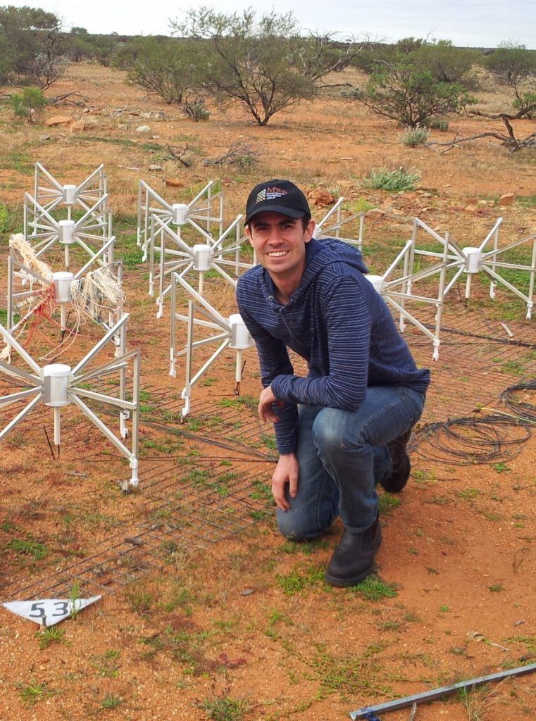 Dr Benjamin McKinley during a trip to the Murchison Widefield Array telescope in outback Western Australia. The 16 metal ‘spiders’ form a single antenna ‘tile’, of which there are 256, spread out across an area of around 6 km in diameter. Dr McKinley and the team are using this radio telescope to observe the Moon in their search for radio signals from the early Universe. Image Credit: Dr Ben McKinley, Curtin University/ICRAR/ASTRO 3D