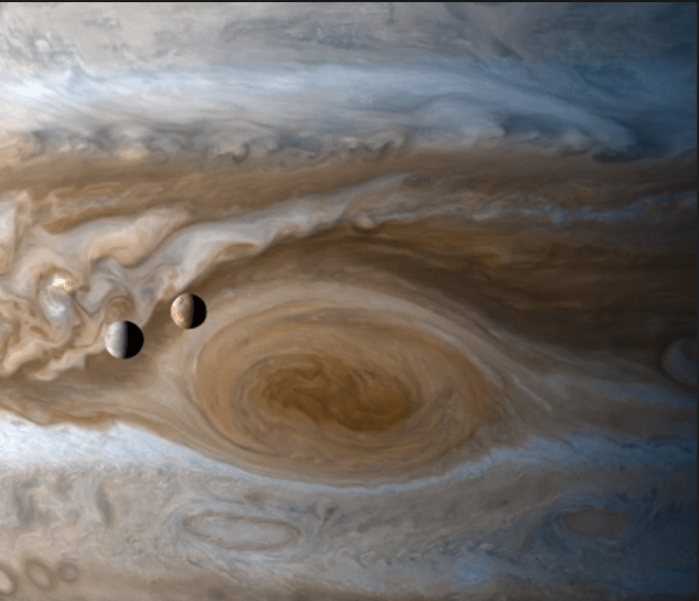 Europa and Io move across the face of Jupiter, with the Great Red Spot behind them. Image: NASA/JPL/Cassini, Kevin M. Gill
