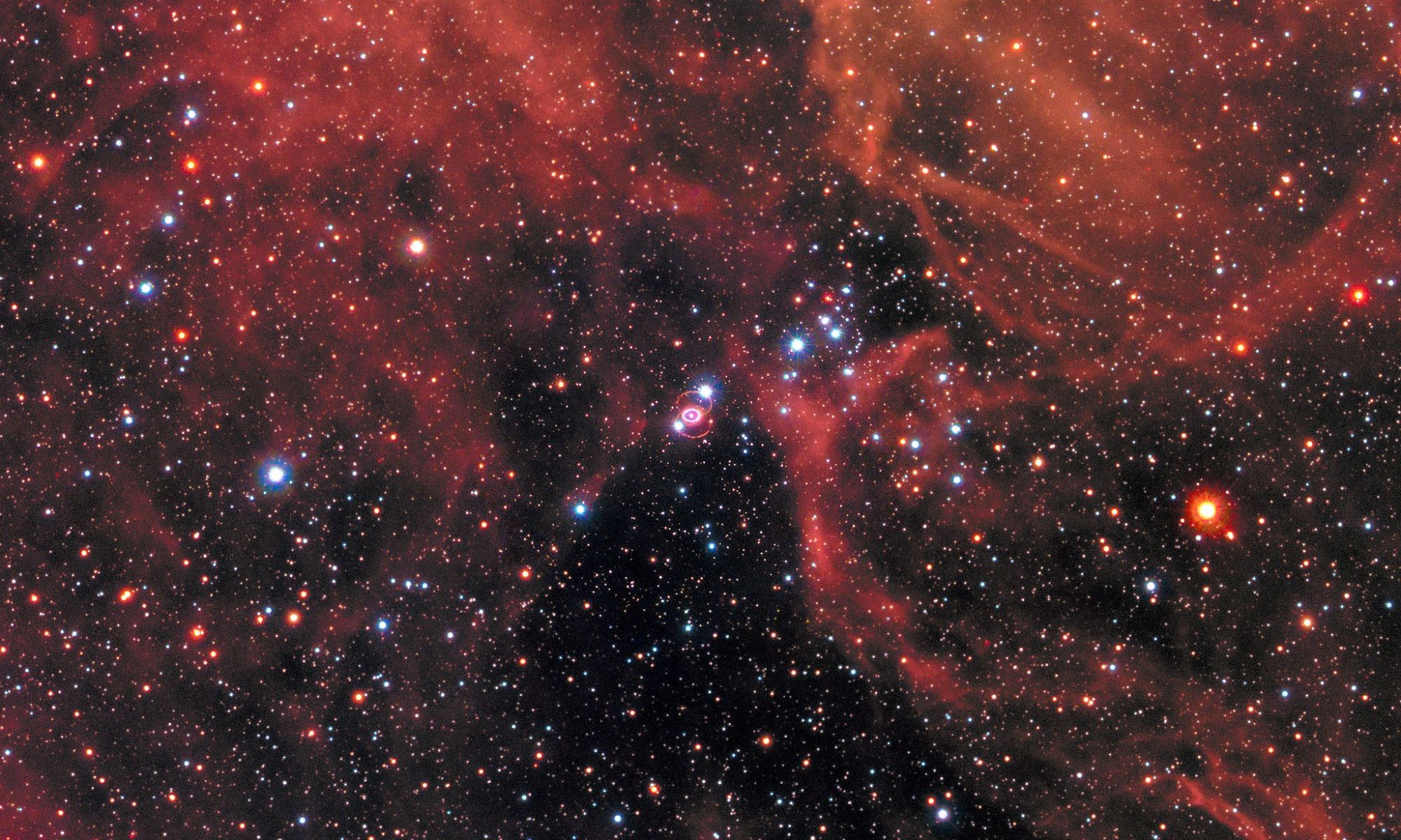 This image of the supernova remnant SN 1987A was taken by the NASA/ESA Hubble Space Telescope in January 2017 using its Wide Field Camera 3 (WFC3). Since its launch in 1990 Hubble has observed the expanding dust cloud of SN 1987A several times has helped astronomers get a better understanding of these cosmic explosions. Supernova 1987A is located in the centre of the image amidst a backdrop of stars. The bright ring around the central region of the exploded star is material ejected by the star about 20 000 years before the actual explosion took place. The supernova is surrounded by gaseous clouds. The clouds’ red colour represents the glow of hydrogen gas. Image Credit: NASA, ESA, and R. Kirshner (Harvard-Smithsonian Center for Astrophysics and Gordon and Betty Moore Foundation) and P. Challis (Harvard-Smithsonian Center for Astrophysics)
