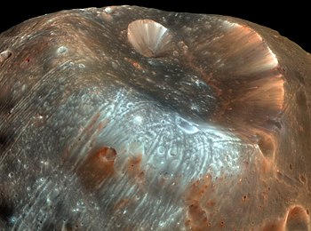 The Mars Reconaissance Orbiter (MRO) captured this image of Phobos and the Stickney crater in 2008. The grooves are clearly visible in the image. Image Credit: NASA/JPL-Caltech/University of Arizona