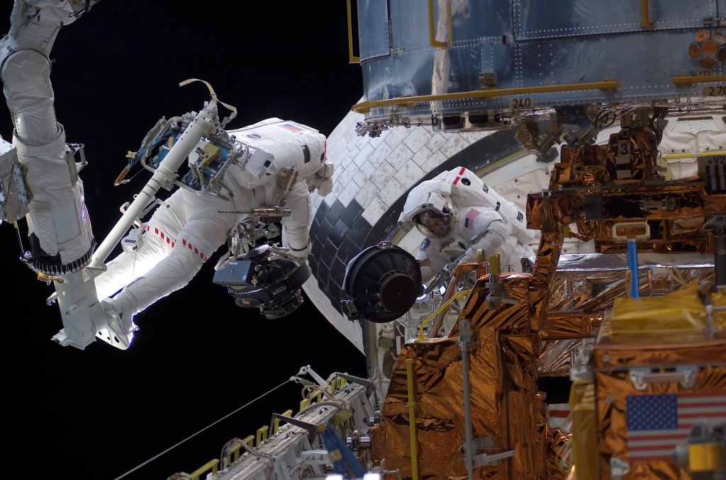 This isn't the first time Hubble has had problems with its pointing system. In this image, astronauts are replacing one of Hubble's reaction wheels in March, 2002. Image Credit: NASA.