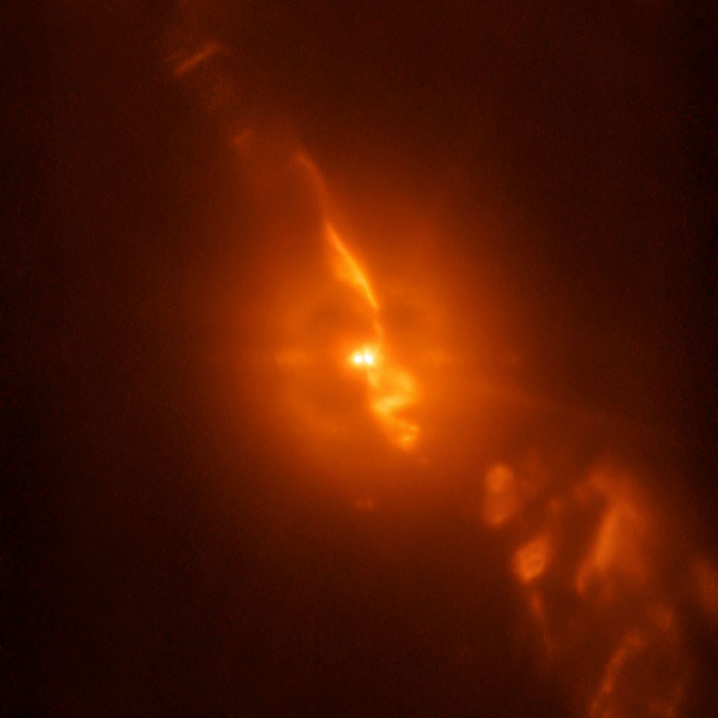 This image is from the SPHERE/ZIMPOL observations of R Aquarii, and shows the binary star itself, with the white dwarf feeding on material from the Mira variable, as well as the jets of material spewing from the stellar couple. Image Credit: ESO/Schmid et al.
